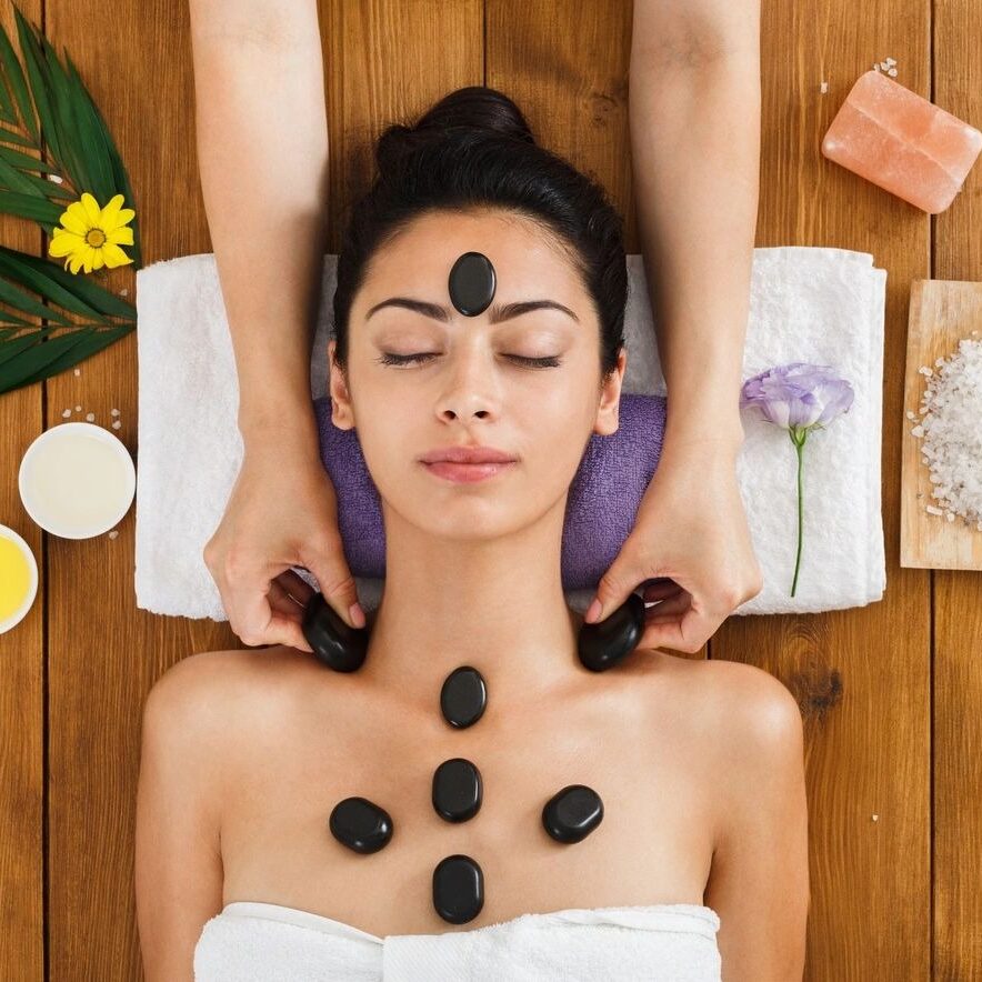 A woman getting her face and neck massaged